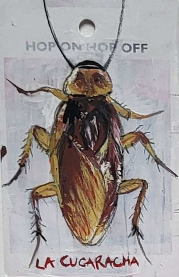 Painting of a cockroach and the Mexican text La Cucaracha below it in red paint, hand written. Above the cockroach is text that is peeping through a layer of paint saying "hop on hop off" the painting is made on a tourist information card.