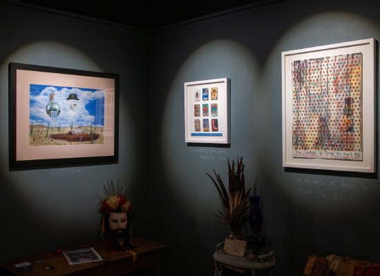 Dark grey gallery walls offset paintings by Red in her exhibition, we learnt to fly. This exhibition showcases Red's collection of work "We Learnt to Fly" about recovery from domestic abuse